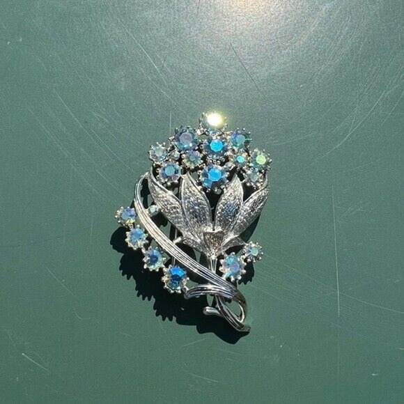 Vintage costume silver and blue gem floral brooch